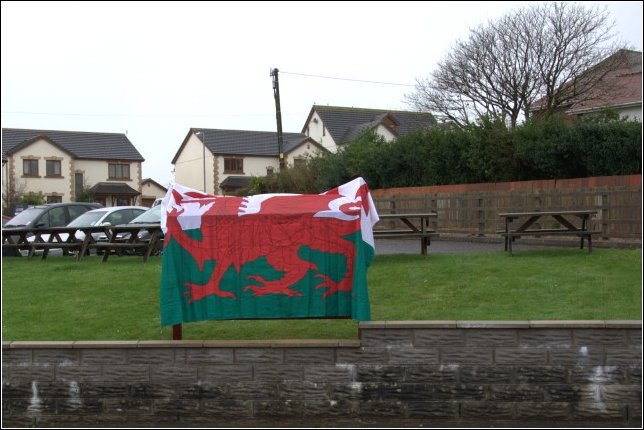 The Ddraig Goch (Welsh Dragon) draped over the panel The Ddraig Goch (Welsh Dragon) draped over the panel