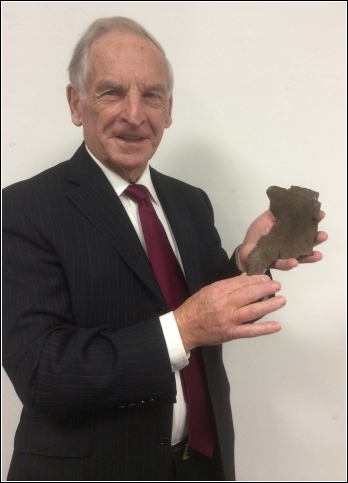 Rev. Milton G Jenkins holding a fragment of the shell Rev. Milton G Jenkins holding a fragment of the shell